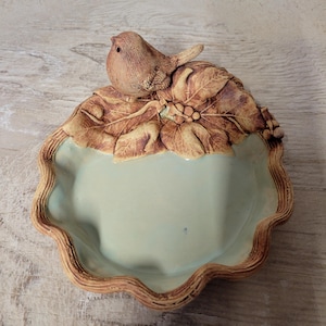 May include: A set of three ceramic mugs with a speckled, matte finish. The mugs are in shades of cream, light gray, and dark gray. Each mug has a simple, minimalist design, perfect for coffee or tea.