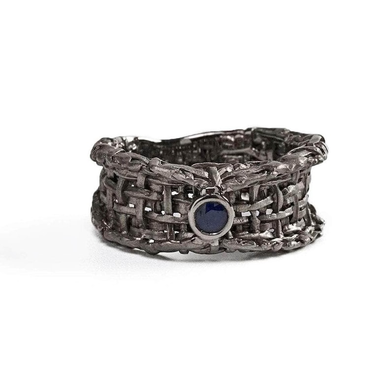 Handmade 925 silver ring with an expressive torn black rhodium-plated design, featuring a deep blue sapphire. A bold, sculptural September birthstone statement ring. Oren Blue Sapphire Ring GERMAN KABIRSKI