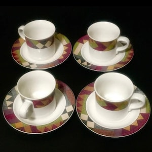 May include: Set of four white ceramic teacups and saucers with a geometric pattern in shades of green, brown, and purple.