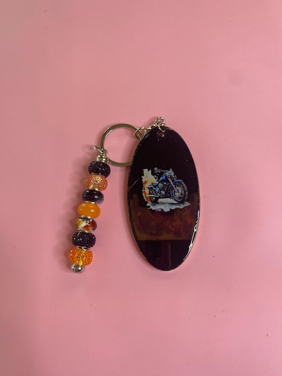 Handmade resin keychain. With Harley Davidson bike on it, this has black/orange beads.