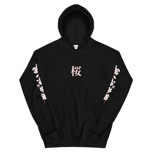 May include: Black hoodie with a pink Japanese character "桜" (Sakura) on the front and pink cherry blossom branches on the sleeves.