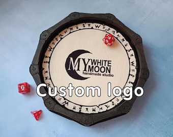 May include: A black octagonal dice tray with a white interior featuring the "My White Moon handmade studio" logo and the words "Custom logo". Three red dice are scattered around the tray.
