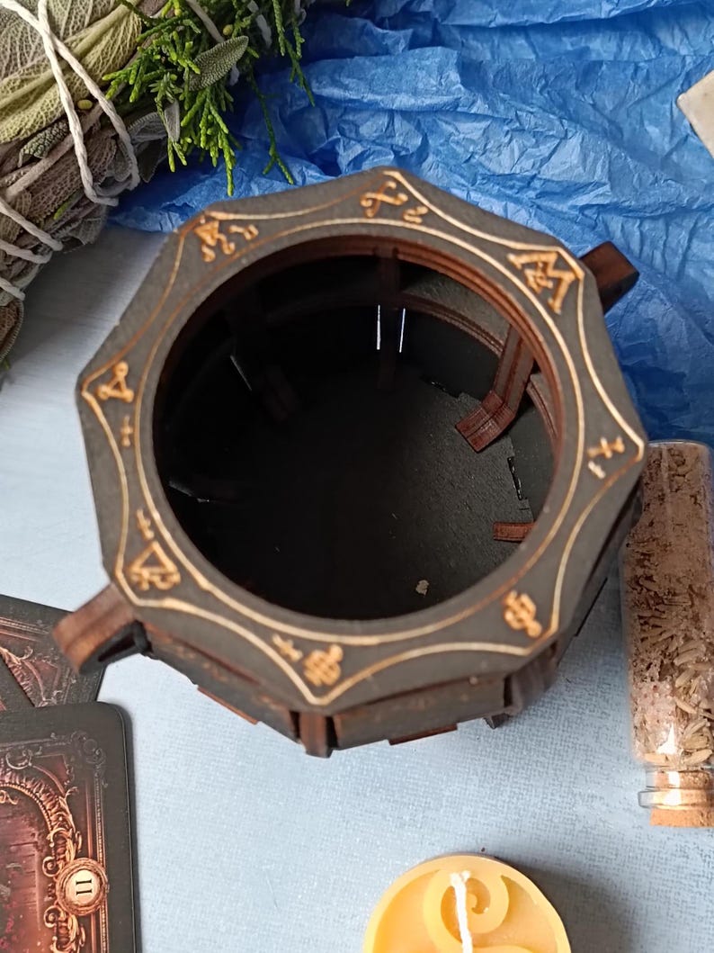 Handcrafted wooden cauldron with aged finish, mystical Wiccan storage box for jewelry, runes, tarot decks, and sacred trinkets, engraved gothic fantasy decor, perfect for pagan rituals and altar setup, dark academia-style wooden storage, rustic handcrafted cauldron chest, magical witchcraft storage, witchy gift idea for Halloween, fantasy altar decor, gothic potion storage, unique arcane symbol box, enchanted wooden Wiccan organizer, witchcraft-themed home decor