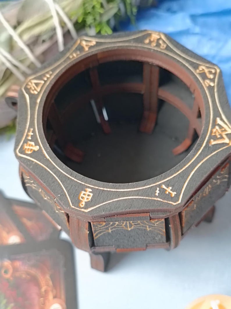Dark gothic wooden cauldron box with mystical symbols, handcrafted fantasy storage for Wiccan jewelry, runes, potions, and herbs, rustic aged altar decor with engraved magical patterns, enchanted spell jar holder, occult-inspired trinket box, witchcraft-themed gothic home decor, handcrafted witchy altar piece, spiritual magic ritual accessory, perfect gothic Halloween decoration, wooden fantasy keepsake storage, dark academia gift for witches and tarot readers