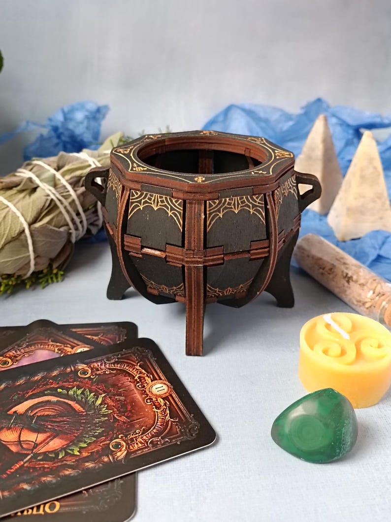 Unique handcrafted witch cauldron box made from wood, engraved with mystical symbols, perfect for storing Wiccan trinkets, spell jars, runes, and magical crystals, enchanted altar decor with gothic aesthetics, rustic aged finish for a fantasy-inspired look, dark academia decor for witches and pagans, perfect Halloween witchcraft accessory, handmade gothic storage for sacred items, fantasy wooden trinket chest, occult-themed altar decoration, handcrafted magical keepsake box