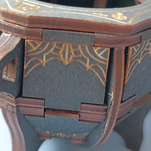 Gothic witch cauldron box, handcrafted wooden storage chest with mystical engravings, perfect for Wiccan spell jars, altar tools, runes, and magic crystals, dark academia aesthetic decor, unique fantasy witchcraft trinket box, distressed wood cauldron with arcane symbols, witchy altar piece, handcrafted pagan ritual decor, enchanted wooden cauldron storage, gothic potion holder, mystical spell storage, rustic witchcraft keepsake, Halloween decor for witches, spiritual altar box