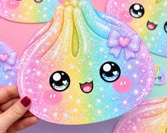 May include: A rainbow-colored dumpling sticker with a glittery finish, featuring a smiling face with large black eyes, pink cheeks, and a small purple bow with a heart center. The design includes a gradient of yellow, blue, and pink hues.