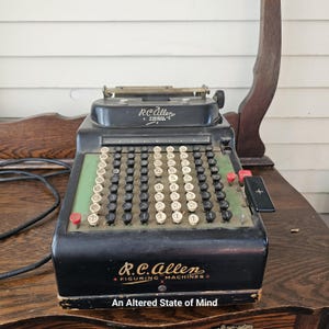 Vintage R.C. Allen figuring machine, electric calculator, old industrial office aesthetic, counting machine, old plug in calculating machine