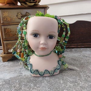 Porcelain doll head planter with hand beaded plant: waterless plant