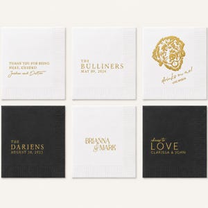 May include: A set of six square paper napkins in white and black, featuring gold foil text and graphics. Designs include personalized names, dates, and phrases like 'Thank you for being here, cheers!', 'The Bulliners', and 'Drinks on me, love Wesson'.