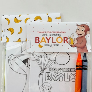May include: A party favor bag with a Curious George theme. The bag includes a coloring page featuring Curious George holding balloons, a thank you tag that says "Thanks for celebrating our little monkey Baylor turning three!" and two crayons.