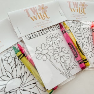 May include: A set of four favor bags with a coloring page and crayons. The bags are decorated with a pink and white floral design and the text "TW Wild" and "Thank you for celebrating with us Sofia".