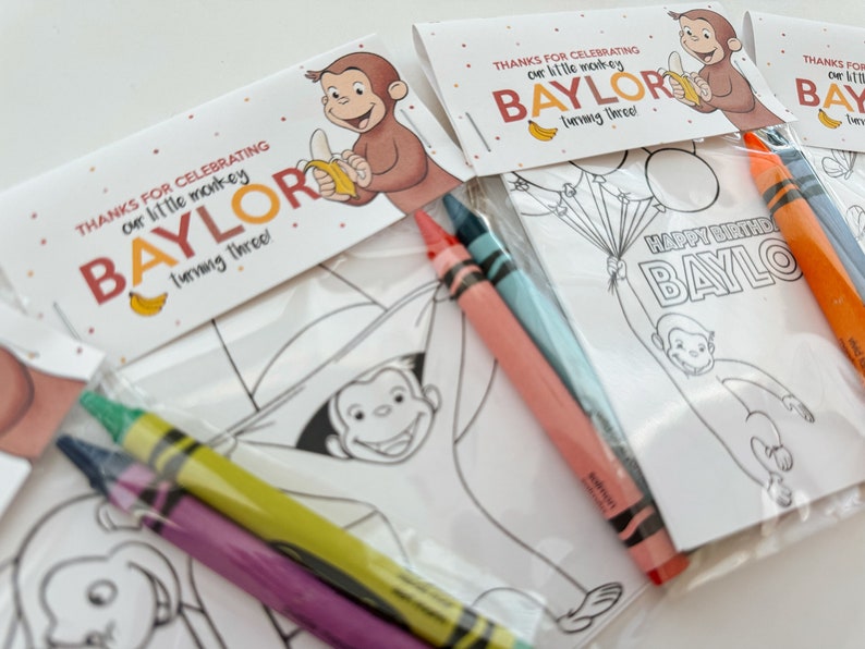 May include: A set of three party favor bags with coloring pages featuring Curious George. Each bag includes three crayons and a tag that says "Thanks for celebrating our little monkey Baylor turning three!"