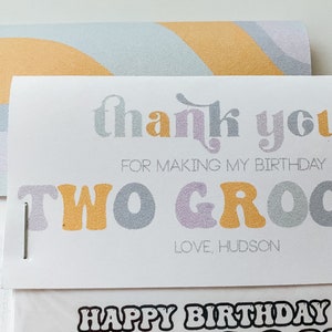 May include: A white thank you card with a rainbow design on the back. The card says "thank you for making my birthday two groovy" and "love, hudson".