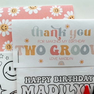 May include: A thank you card with a pink and white daisy pattern. The card says "thank you for making my birthday two groovy" and "love, Madilyn". The card is attached to a colouring page with the text "Happy Birthday Madilyn".