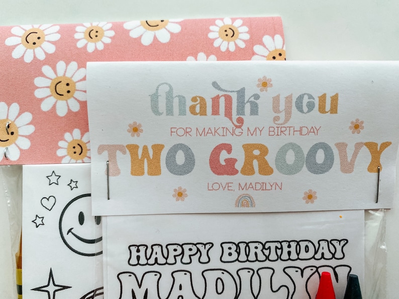 May include: A thank you card with a pink and white daisy pattern. The card says "thank you for making my birthday two groovy" and "love, Madilyn". The card is attached to a colouring page with the text "Happy Birthday Madilyn".