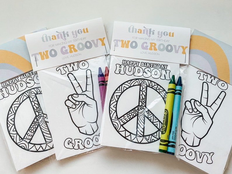 May include: Three colourful thank you cards with the text "Thank you for making my birthday two groovy" and "Love, Hudson". Each card is paired with a colouring page featuring a peace sign, a hand making the peace sign, and the text "Two Groovy". Crayola crayons are included.