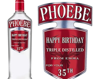 May include: A red and silver personalized liquor bottle label with the name "PHOEBE" and the text "Happy Birthday Triple Distilled From Emma For Your 35th".