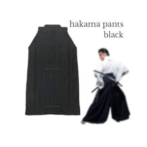 May include: Black hakama pants, a traditional Japanese garment, are displayed. The pants are pleated and have a wide, flowing design. The text "hakama pants black" is visible in the image.