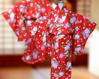 May include: A red kimono with white and pink floral patterns. The kimono has a traditional Japanese design and is perfect for special occasions.