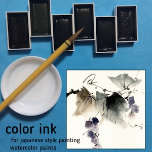 May include: A set of watercolour paints and ink for Japanese-style painting. The image shows rectangular paint trays, a brush, a white dish, and a watercolour painting of grapes and leaves. The text reads "color ink for japanese style painting watercolour paints."
