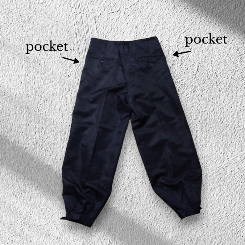 May include: Dark navy blue trousers with a high waist and two pockets. The trousers have a wide leg design and are made of a smooth fabric. The pockets are indicated with the word "pocket".
