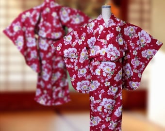 May include: Two red and white floral print yukatas, traditional Japanese robes, with a pink and white floral pattern.