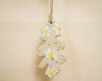 Hand-painted ceramic Christmas hanger with handpainted white flowers