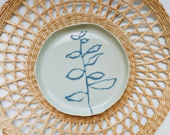 Ceramic decorated plate with blue glaze