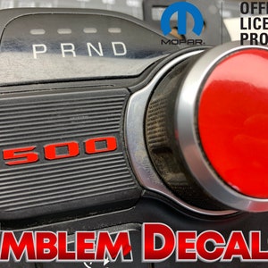 May include: Red and black car emblem decal with the text "1500" and "PRND" on a black background. The decal is an official licensed product.