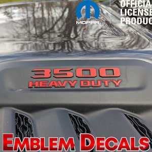 May include: Red 3500 Heavy Duty emblem decal for a truck. The decal is black with red lettering and is an officially licensed Mopar product.