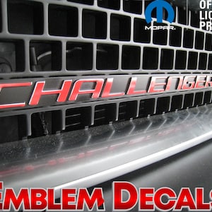 May include: Red "CHALLENGER" emblem decal for a car grille. The decal is made of high-quality vinyl and is designed to last for years. It is easy to apply and remove without damaging the paint.