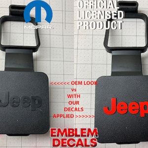 May include: Two Jeep tailgate emblems, one with a red Jeep logo and the other with a black Jeep logo. The text "OEM LOOK VS WITH OUR DECALS APPLIED" is printed below the emblems.