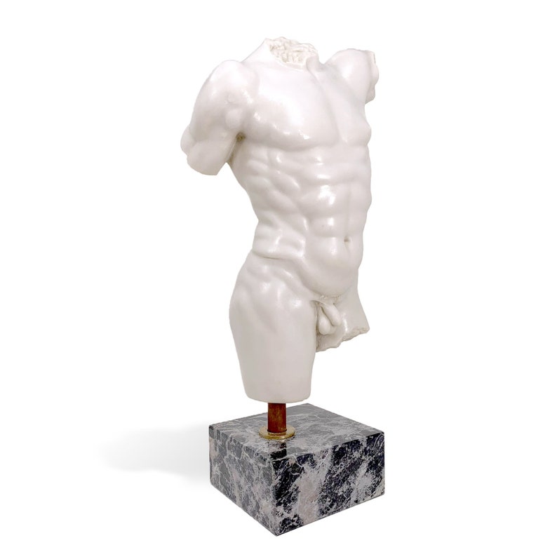 May include: White marble sculpture of a male torso on a black marble base. The sculpture is headless and has a detailed muscular physique.