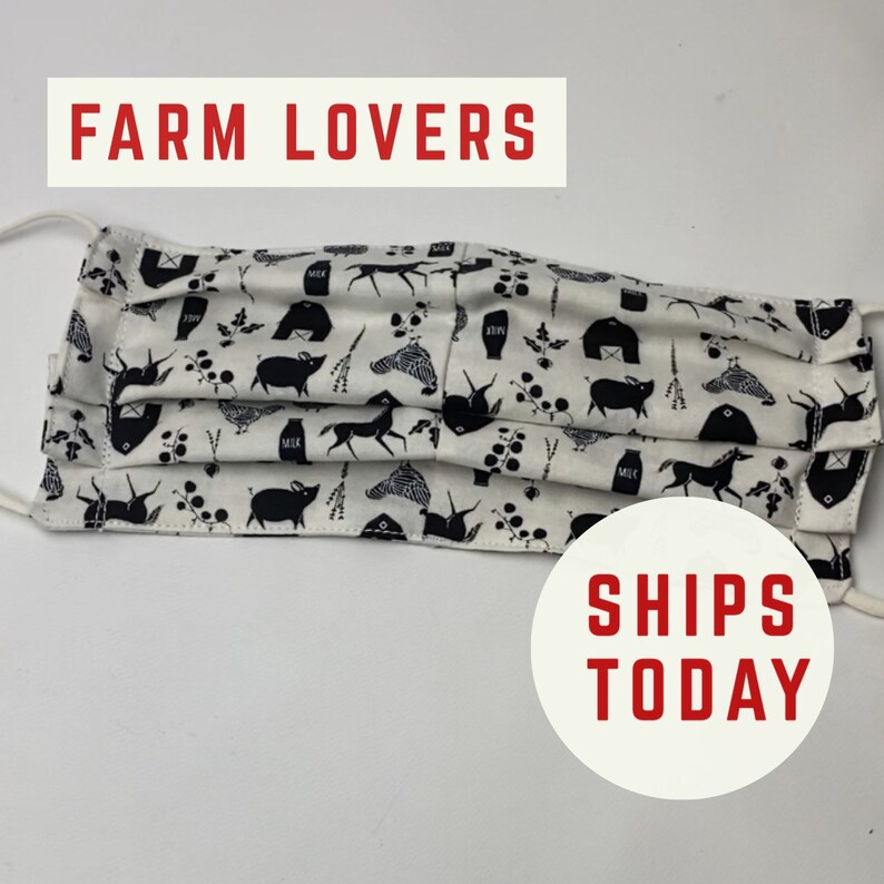 May include: White face mask with a black and white farm animal print. The print includes pigs, chickens, cows, and barns. The text "FARM LOVERS" is at the top of the image and "SHIPS TODAY" is at the bottom of the image.