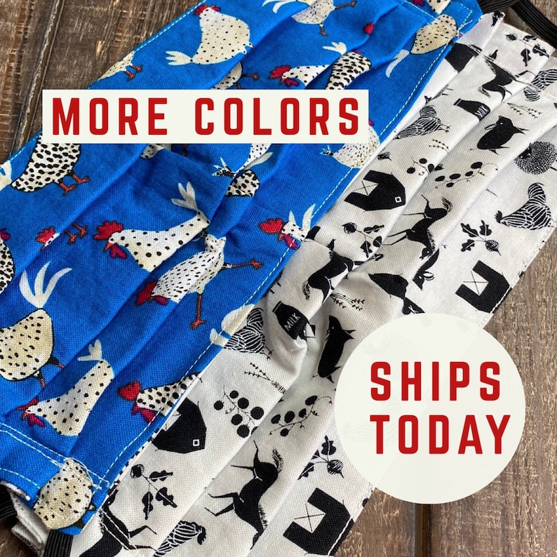 May include: Two fabric face masks with different patterns. The top mask is blue with white chickens and the bottom mask is white with black farm animals. The text "MORE COLORS" is on the top of the image and the text "SHIPS TODAY" is on the bottom of the image.