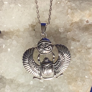 Egyptian scarab pendant made with sterling silver, winged scarab holding an Horus, Ra eye