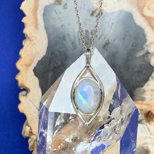Moonstone pendant set with sterling silver, blue and rainbow reflection stone