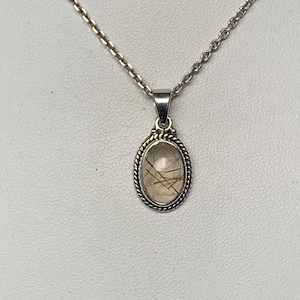Rutilated quartz pendant set with sterling silver, golden rutile, finely worked