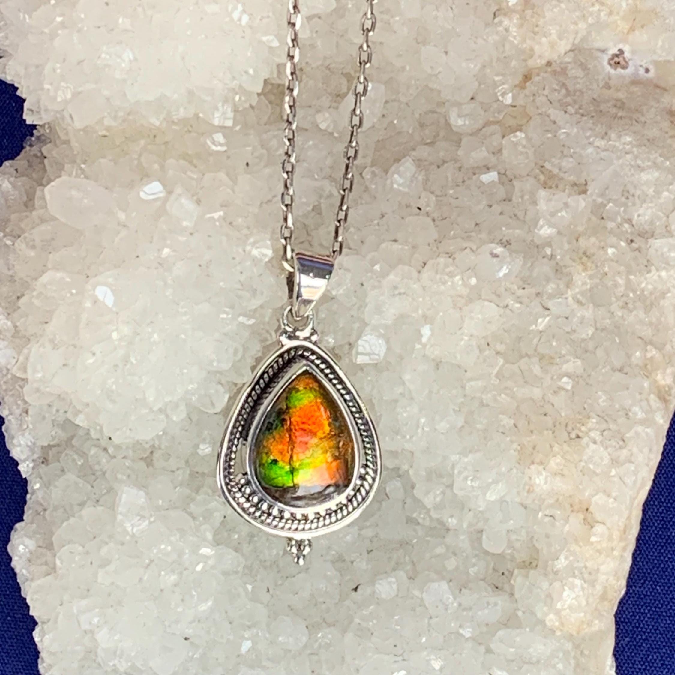 Ammolite pendant set with sterling silver, red and green reflection gemstone