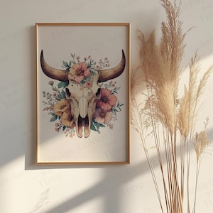 May include: A framed print of a white bull skull with pink and yellow flowers around it. The skull is surrounded by a wreath of flowers. The background is white.