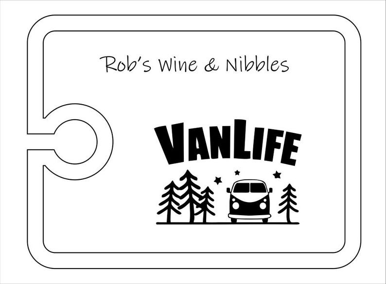 May include: A rectangular white serving board with a rounded cutout on the left side. The board features the black text Rob's Wine & Nibbles at the top and a black graphic below consisting of the word VANLIFE, pine trees, stars, and a camper van.