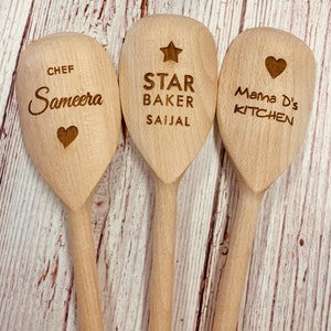 May include: Three wooden spoons with personalized engravings. The first spoon says "Chef Sameera" with a heart. The second spoon says "Star Baker Saijal" with a star. The third spoon says "Mama D's Kitchen" with a heart.