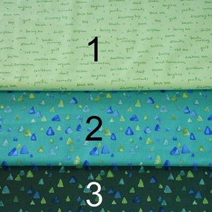 May include: Three fabric swatches with different patterns. The top swatch is light green with black text, the middle swatch is teal with blue triangles, and the bottom swatch is dark green with blue triangles.