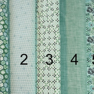 May include: Five fabric swatches in shades of green and blue. The swatches are numbered 1 to 5. The fabrics feature various patterns, including geometric designs, polka dots, and floral prints.
