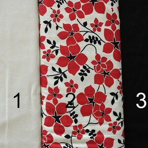 May include: Three fabric swatches, labeled 1, 2, and 3.  Swatch 1 is a plain white fabric. Swatch 2 is a white fabric with a red and black floral print. Swatch 3 is a black fabric.