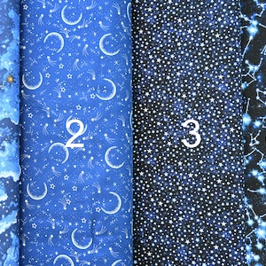 May include: Four different fabric swatches with a blue and white star pattern. The first swatch has a cloudy sky design, the second has crescent moons and shooting stars, the third has a scattered star design, and the fourth has a constellation design.