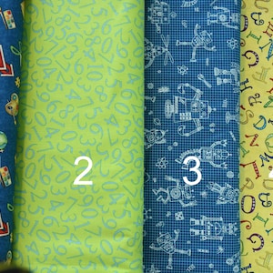 May include: Four fabric swatches with different patterns. The first swatch is blue with a school-themed pattern, the second is green with a pattern of numbers, the third is blue with a pattern of robots, and the fourth is yellow with a pattern of letters.
