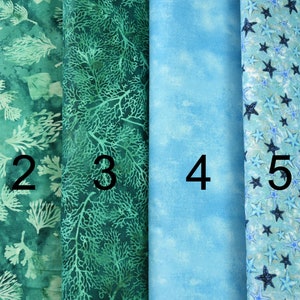 May include: Six fabric swatches in various shades of blue and green. The swatches are numbered 1 through 6. The fabric patterns include a floral design, a coral reef design, a cloud design, a star design, and a seahorse design.