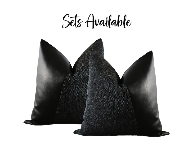 May include: Two decorative throw pillows. The pillows have a black leather-like material on the sides and a textured dark gray fabric in the center. The text "Sets Available" is written in cursive at the top.